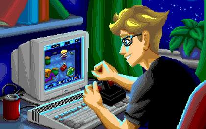 Un giocatore utilizza un computer Amiga per giocare a Kaboomania in una scena dal sapore retro