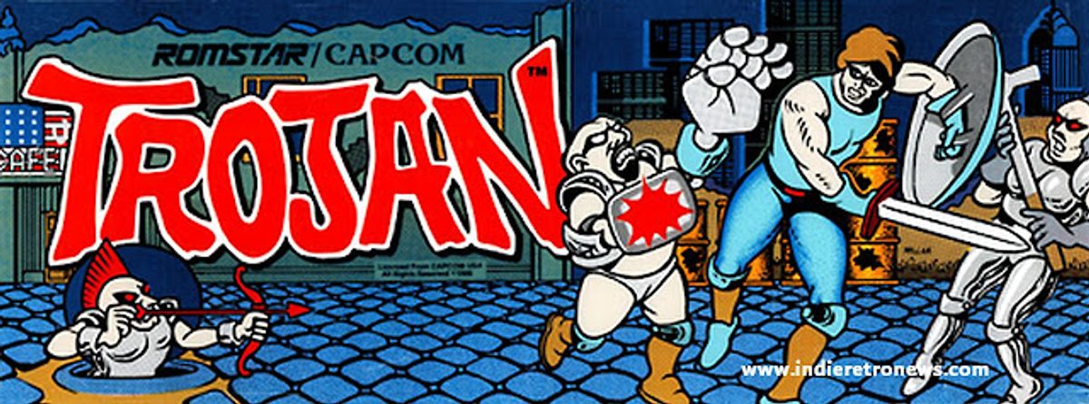 Schermata del titolo di Trojan con logo e personaggi in stile arcade.