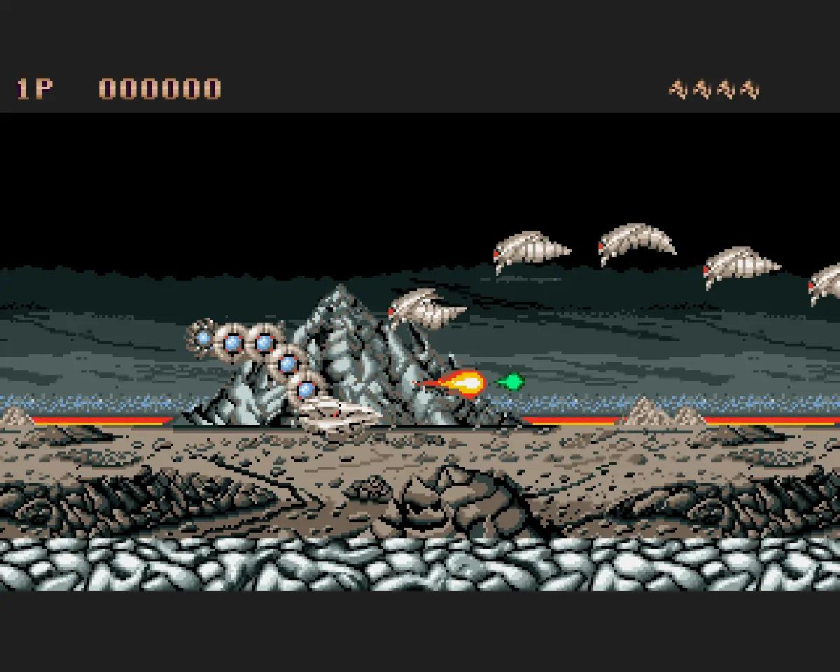 Saint Dragon su Amiga con il drago meccanico protagonista in uno scenario roccioso.