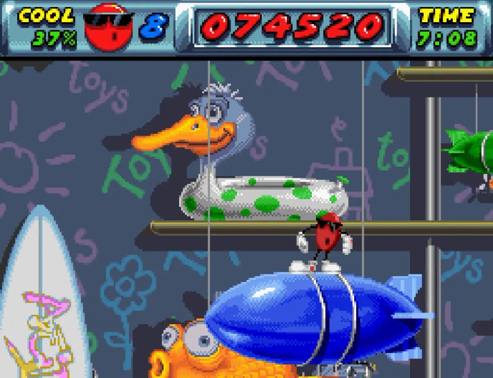 Cool Spot esplora uno scenario pieno di oggetti ingigantiti nella versione SNES.