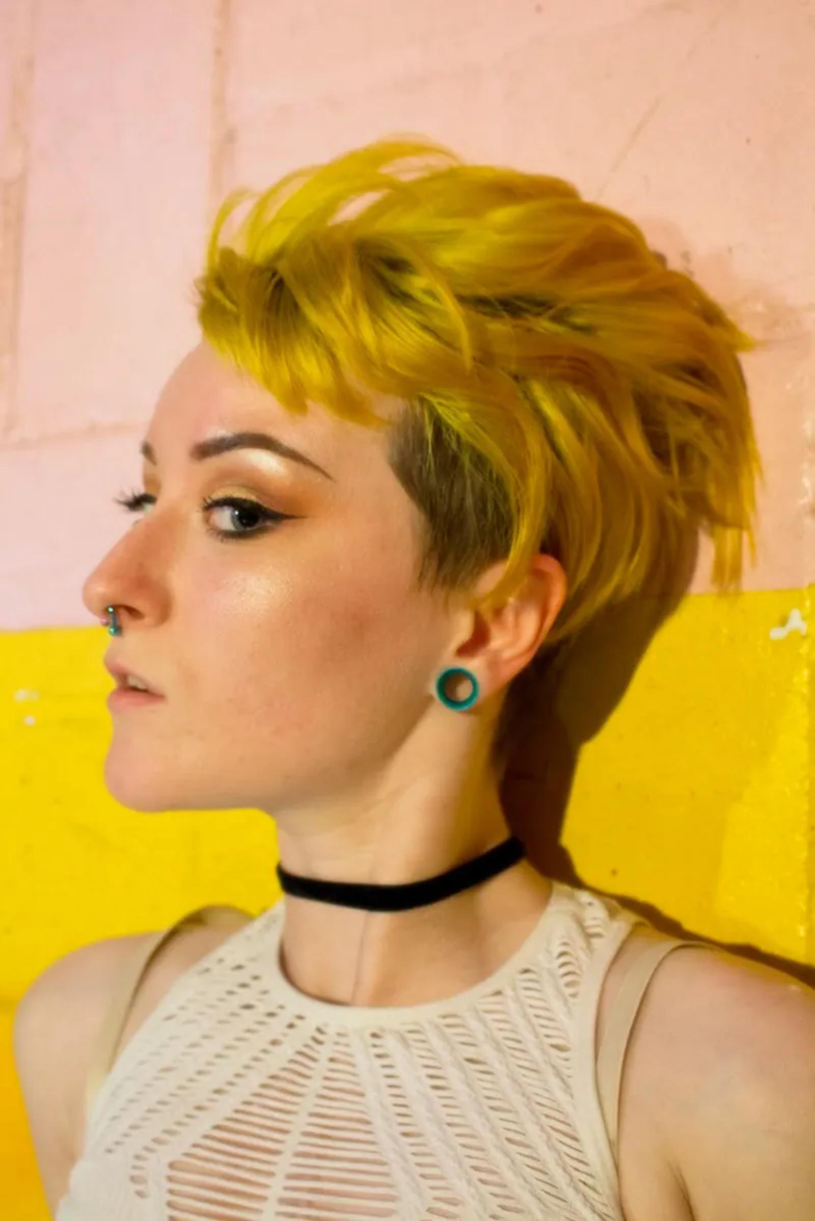 Portrait against a painted yellow wall