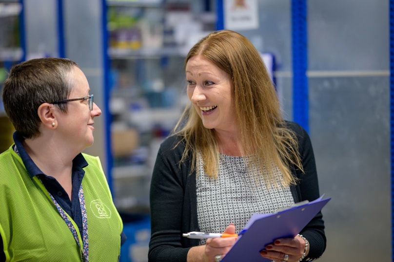 Two colleagues reviewing compliance documentation