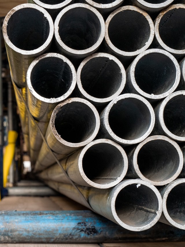 Stacks of metal tubing on a production floor