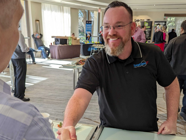 TotalCare IT team member greeting an attendee