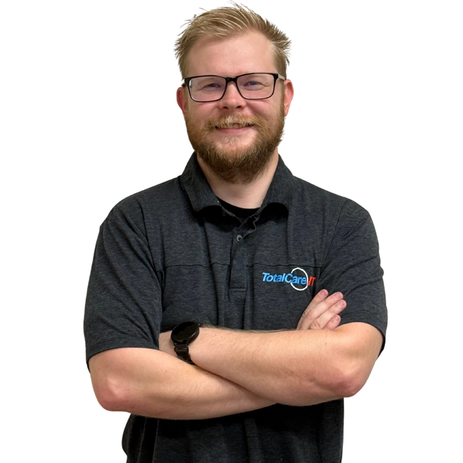 TotalCare IT engineer standing with arms crossed