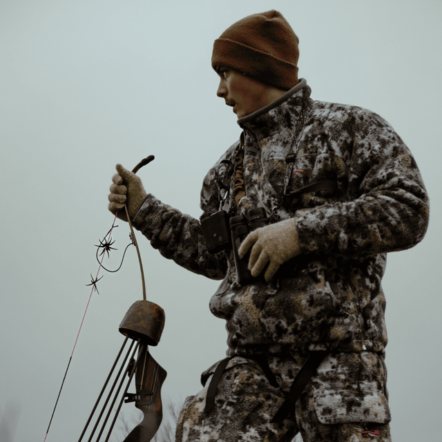 Bow hunter carrying archery equipment