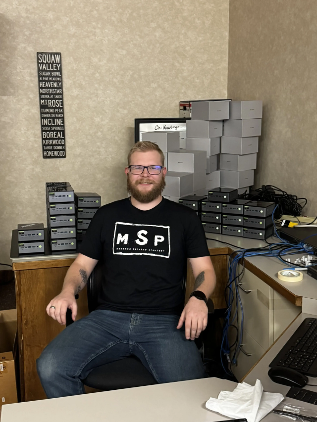 Internal IT professional working in an equipment room