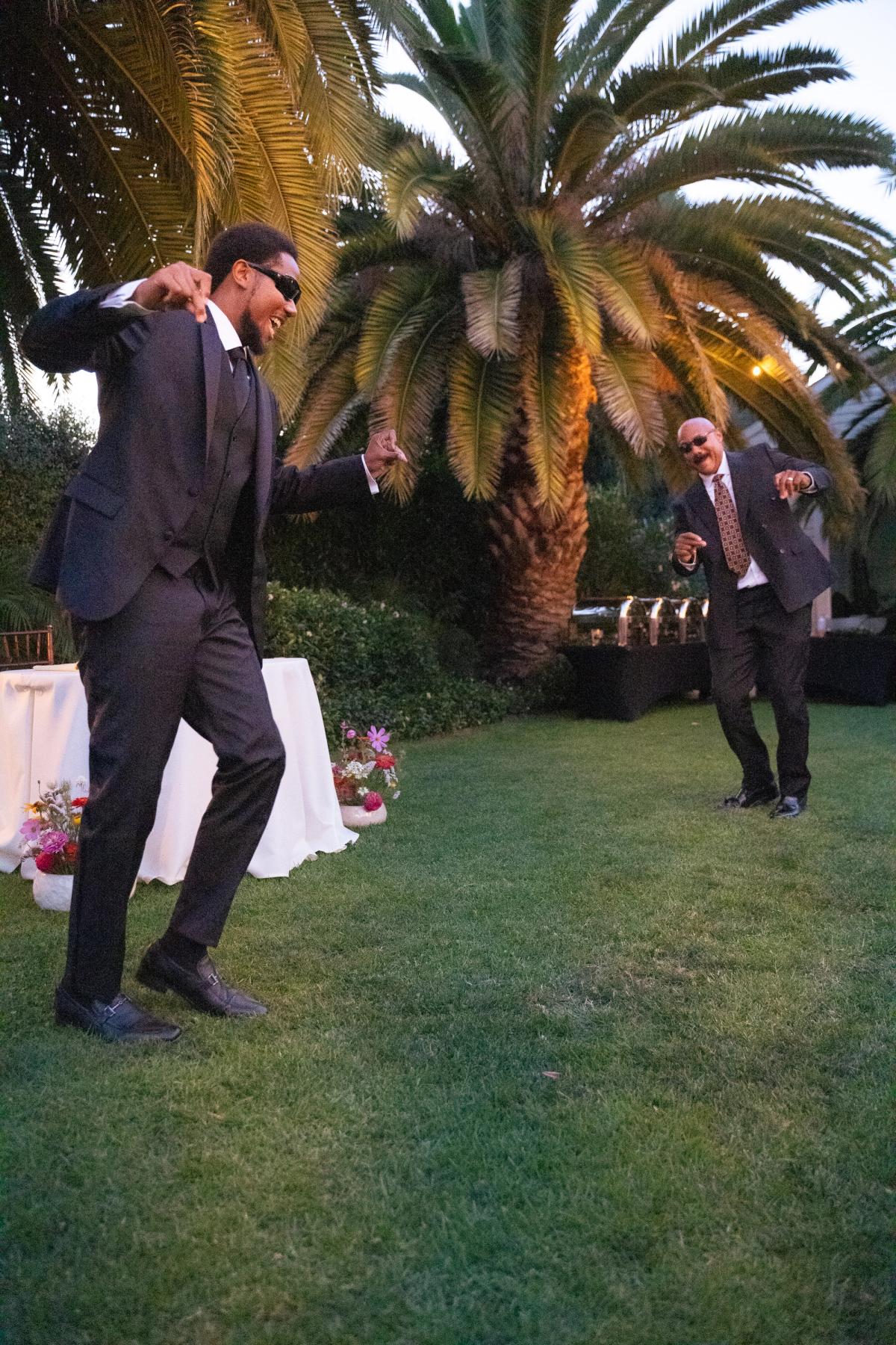 Groom and his father dancing together at their wedding