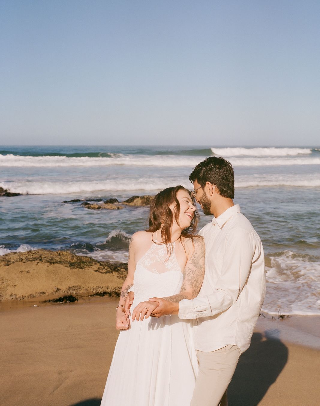 Engaged couple posing on the beach 