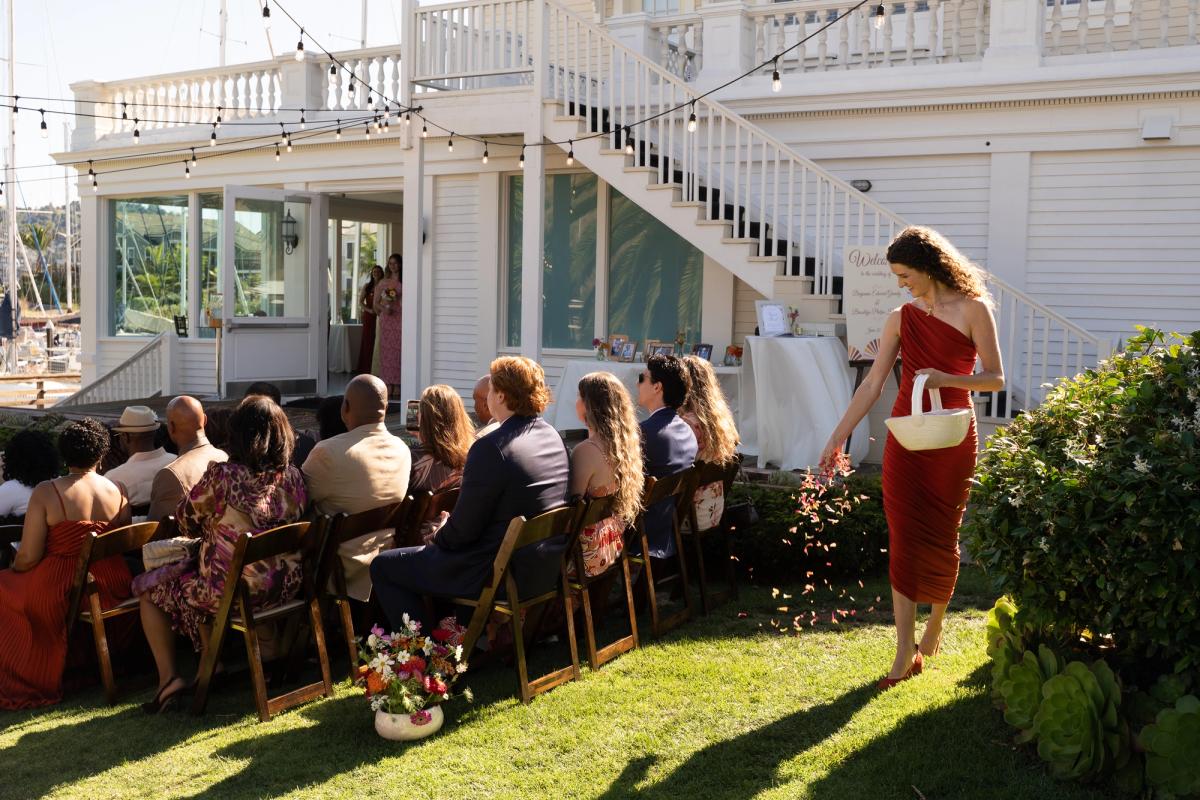 Wedding ceremony with flower girl spreading petals