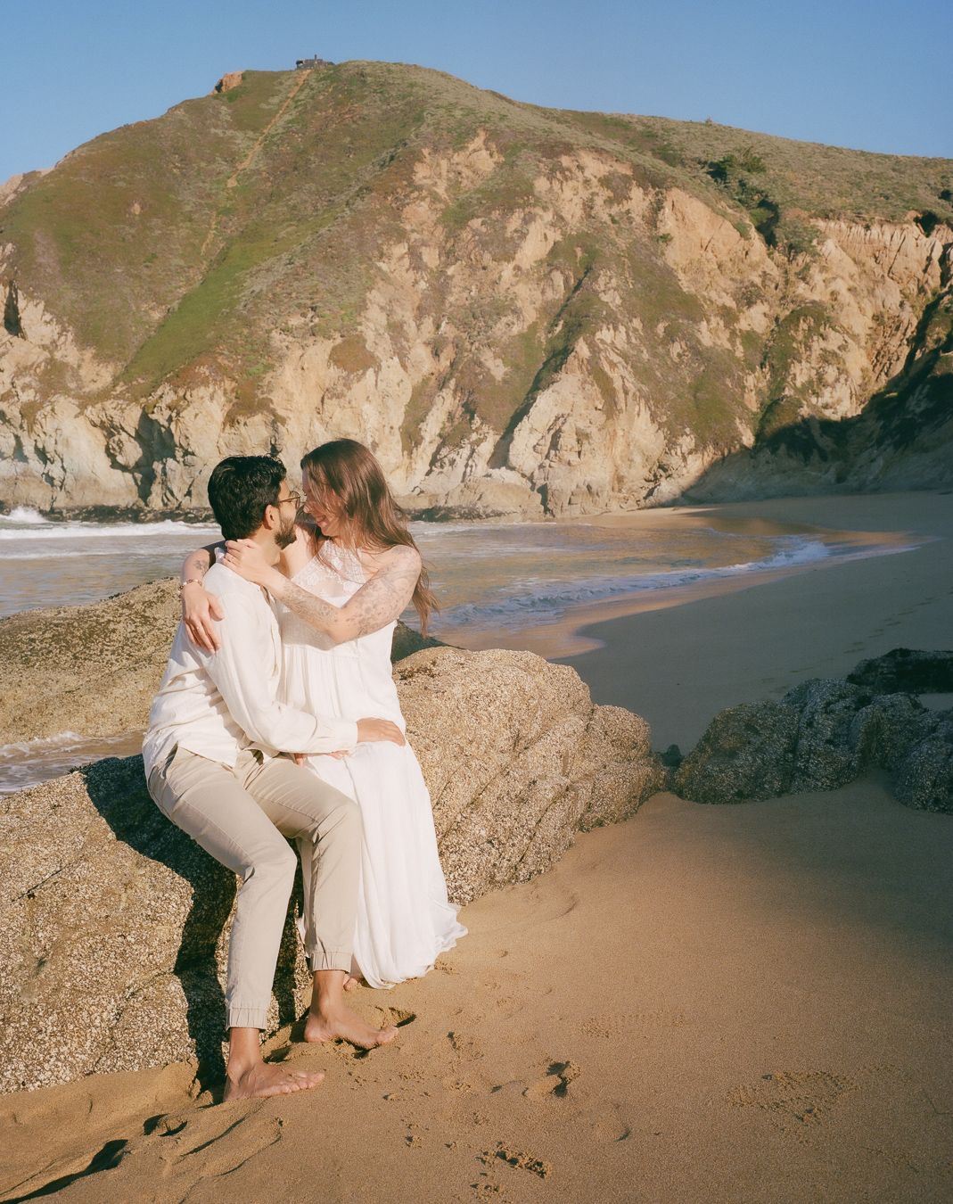 Engaged couple posing on the beach 
