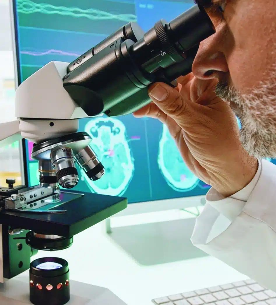 Lab researcher looking into a microscope