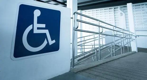 A large wheelchair access sign at the top of a ramp