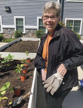 Liz Beman working on a flower box.
