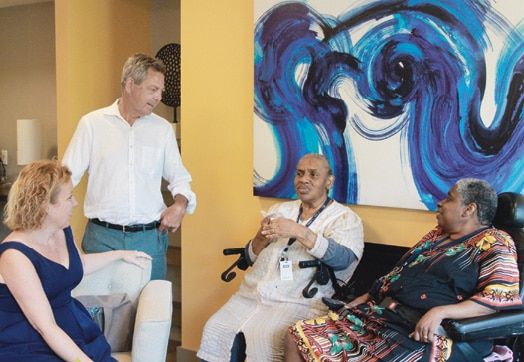 Tara Mizrahi, vice president of Affirmative Investments; David Ennis, president of Affirmative Investments; and residents Theresa Norwood and Hart and Loretta Martin