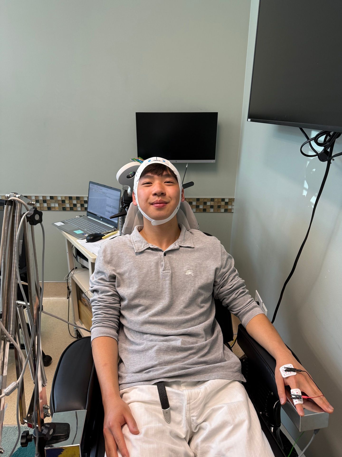 A young man hooked up to medical testing equiptment.