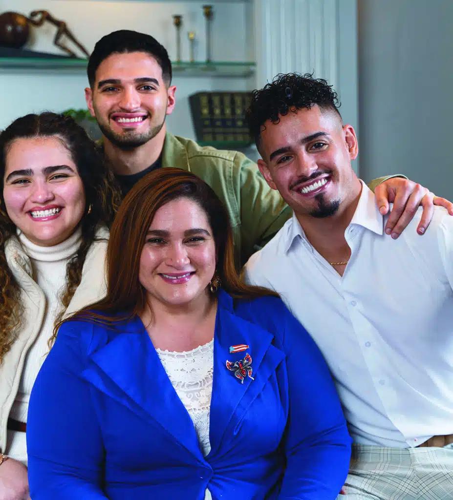 Luz Loeb poses with her three adult children