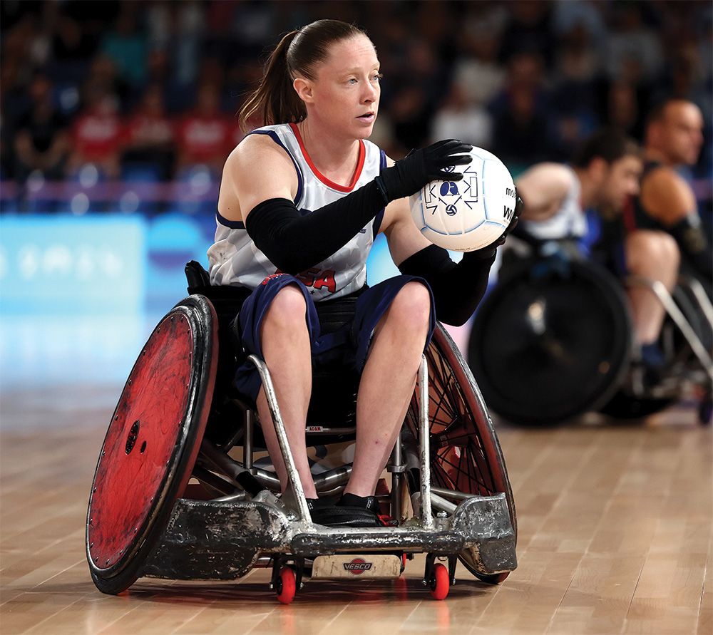 Sarah Adam on the rugby court, holding the ball.