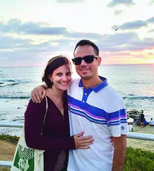 Adrian Dickerson and his wife, Elaine, pose together in front of a body of water