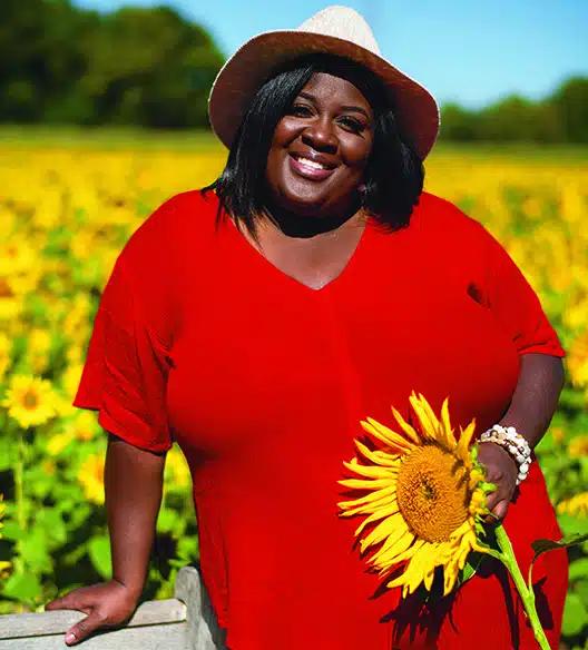 Nicole White holding a sunflower