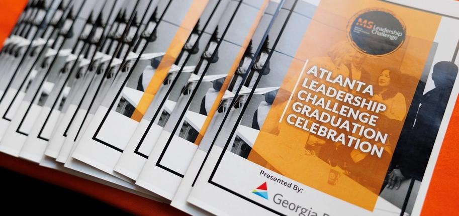 A stack of programs for the Atlanta Leadership Challenge Graduation Celebration.