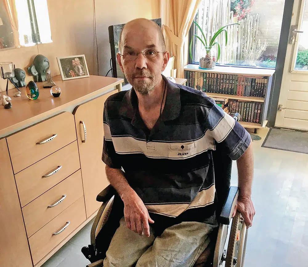 Tom Bellas sits in his wheelchair