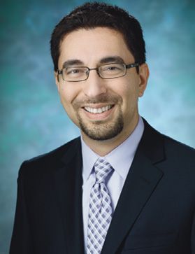 Bardia Nourbakhsh, MD, wears a suit and glasses and has a goatee