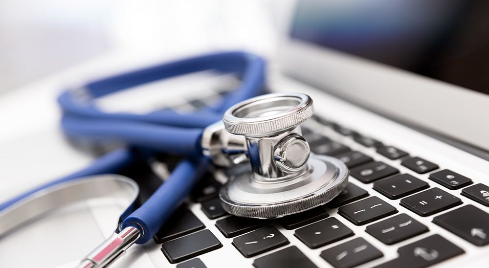 A stethoscope on a laptop.