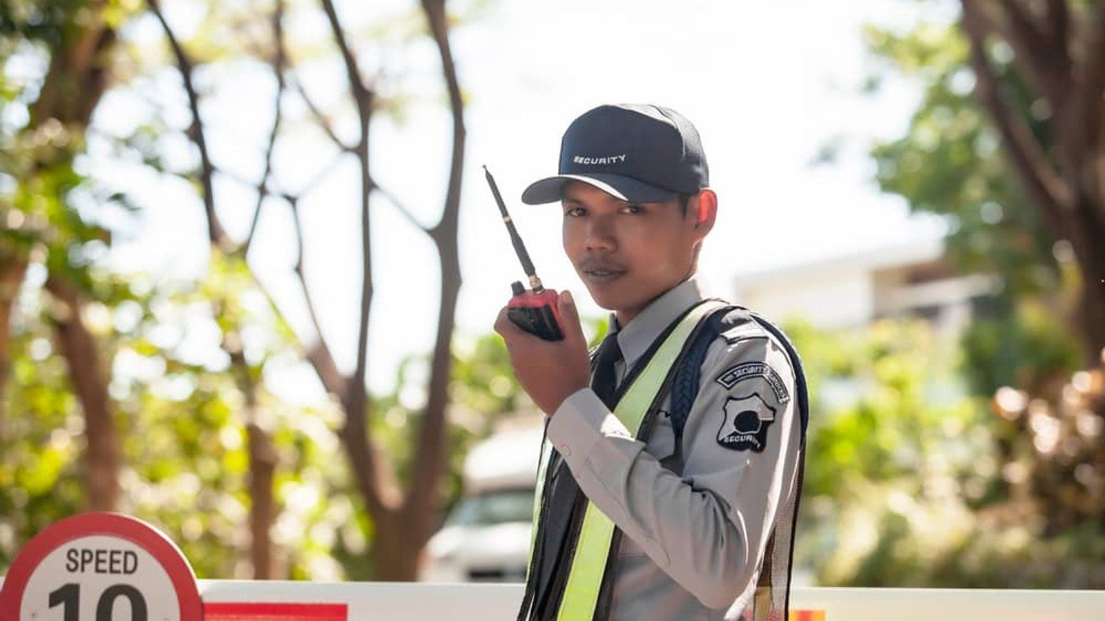 Whitehand security guard on duty with a radio at a gated premises in Bangalore, reliable security solutions
