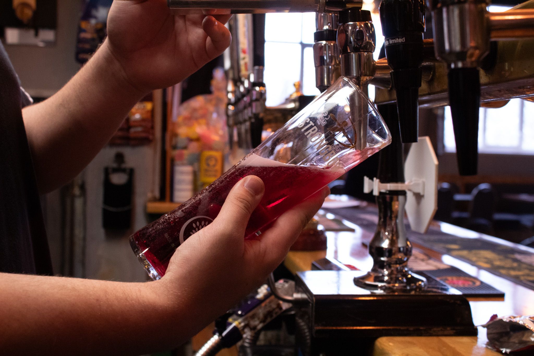 A cider being poured at the bar.