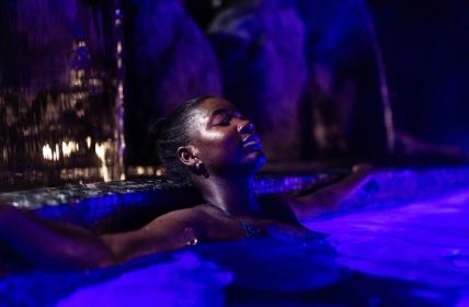 Women relaxing as the steam rises from an outdoor thermal pool.