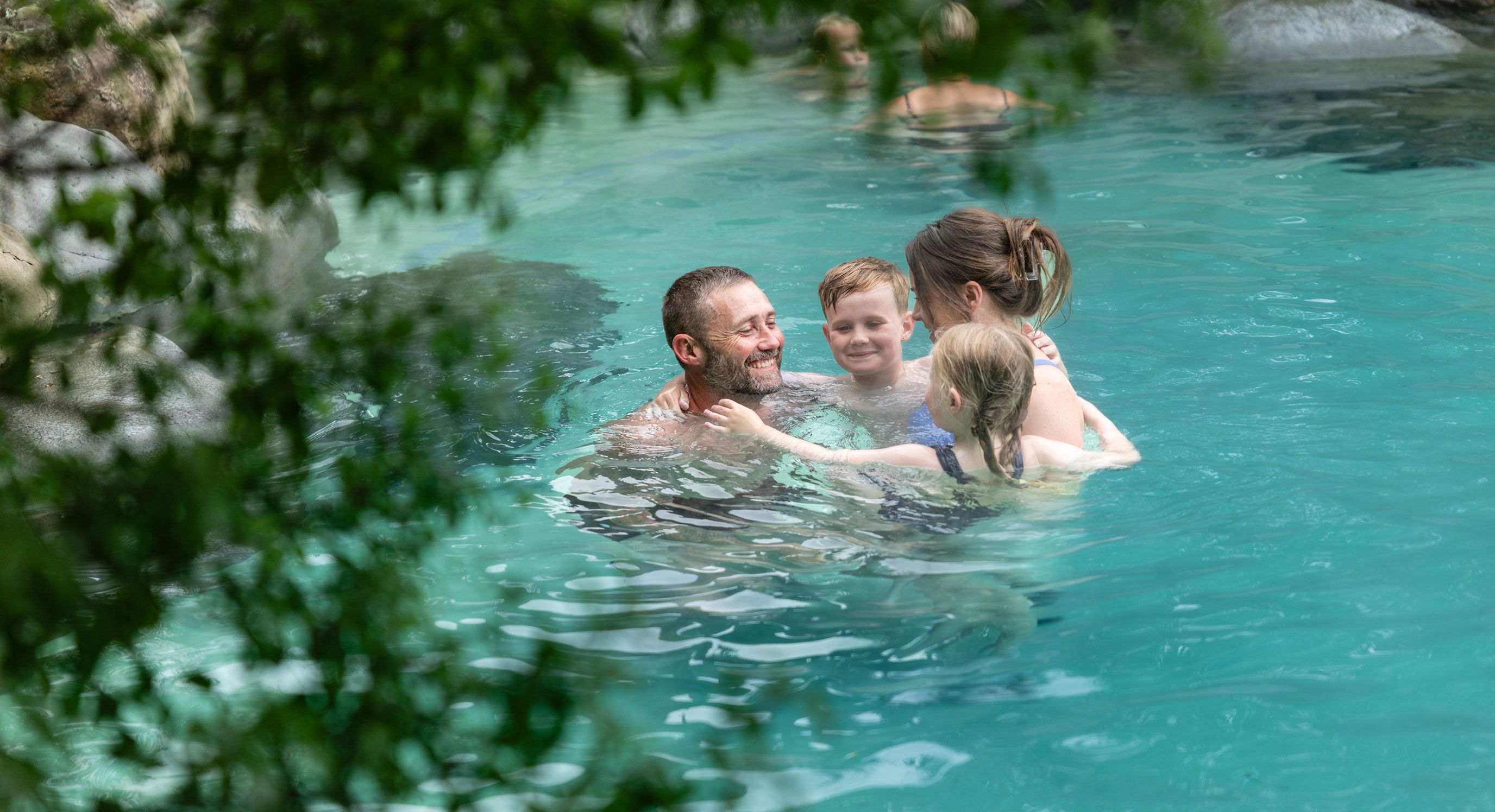 A family smiling, connecting and having a fun moment together about us Hanmer Springs Pools and Spa
