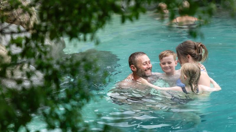 A family smiling, connecting and having a fun moment together about us Hanmer Springs Pools and Spa