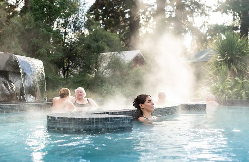 A woman relaxes alone in the thermal pools which is a gift at the the Hanmer Springs thermal pool