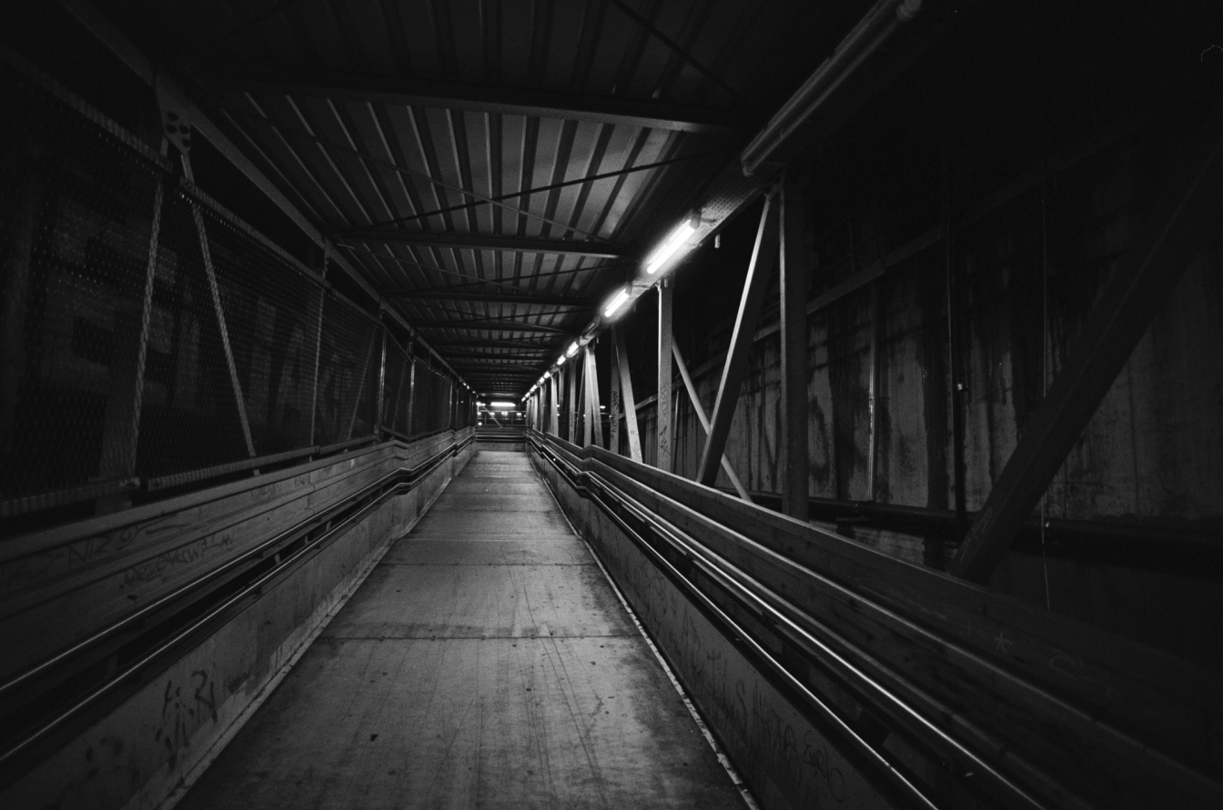 Wide angle photo of a tunnel in a construction site, black and white. Shot on Ilford HP5.