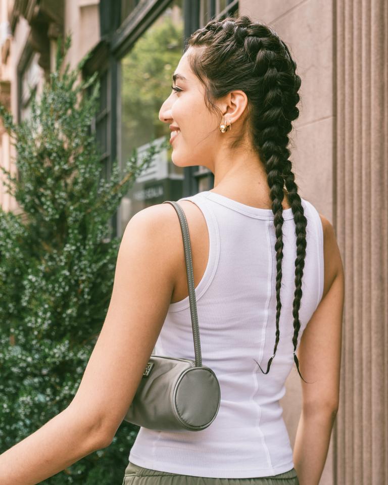 Model wearing sleek boxer braids, a protective workout hairstyle that keeps hair secure and stylish.