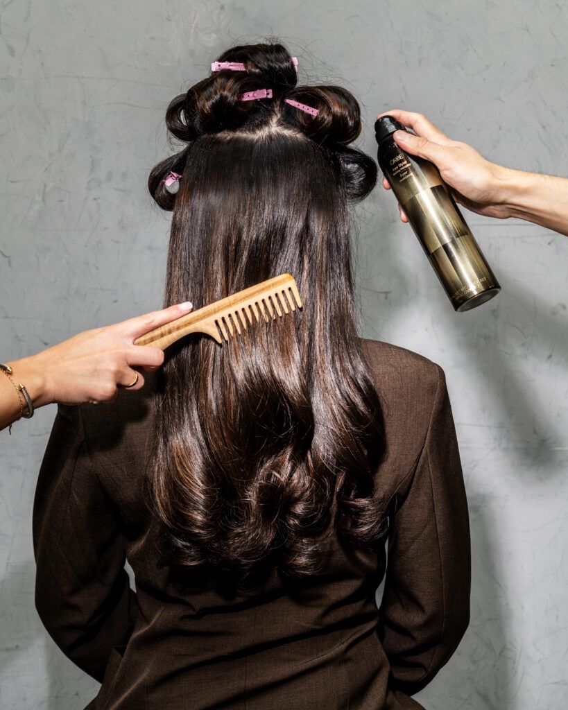 Brunette client at Fabio Scalia Salon NYC being styled from the back using Oribe hairspray and a FS Leo comb