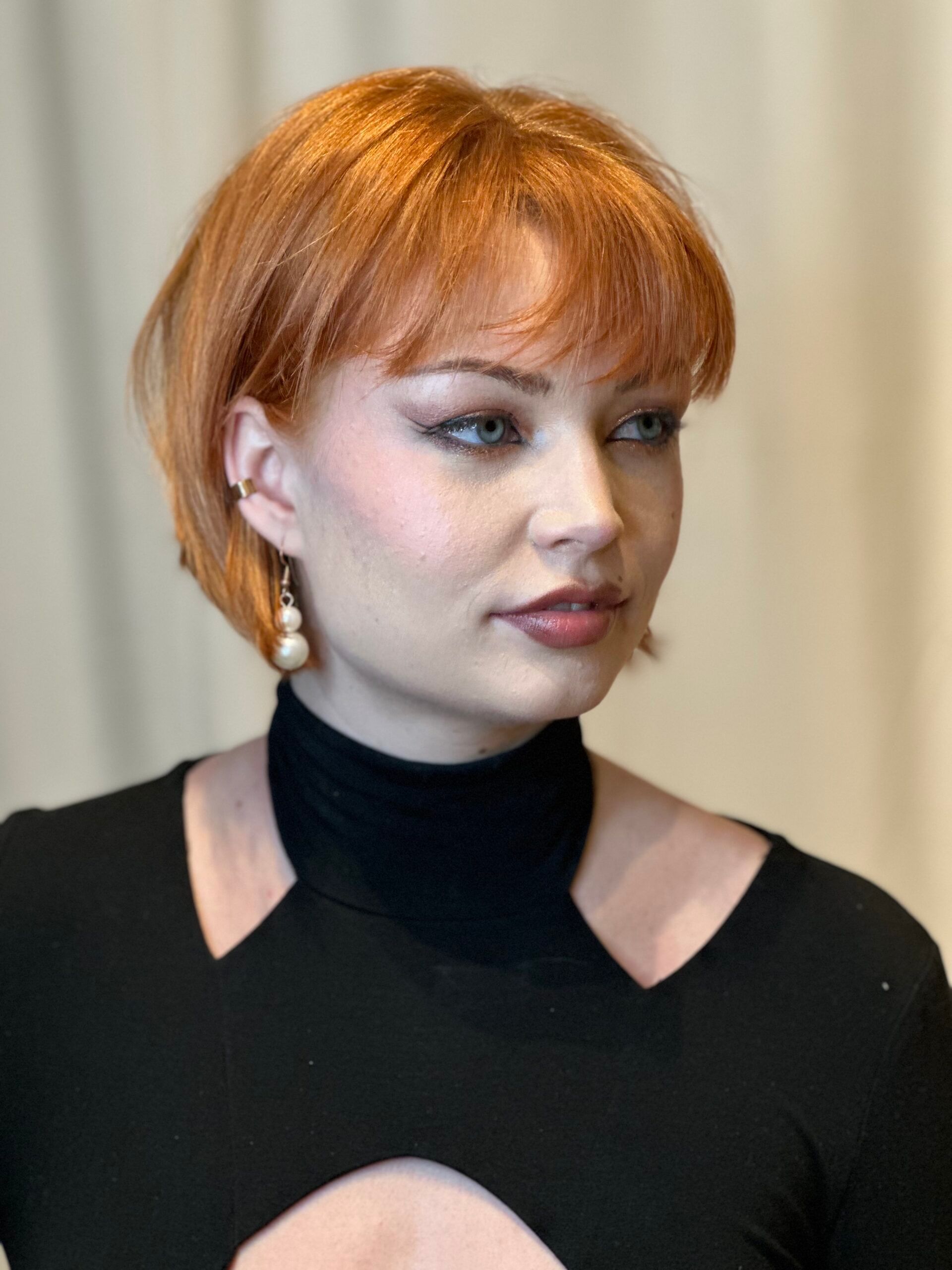 Image of a woman with short, copper hair