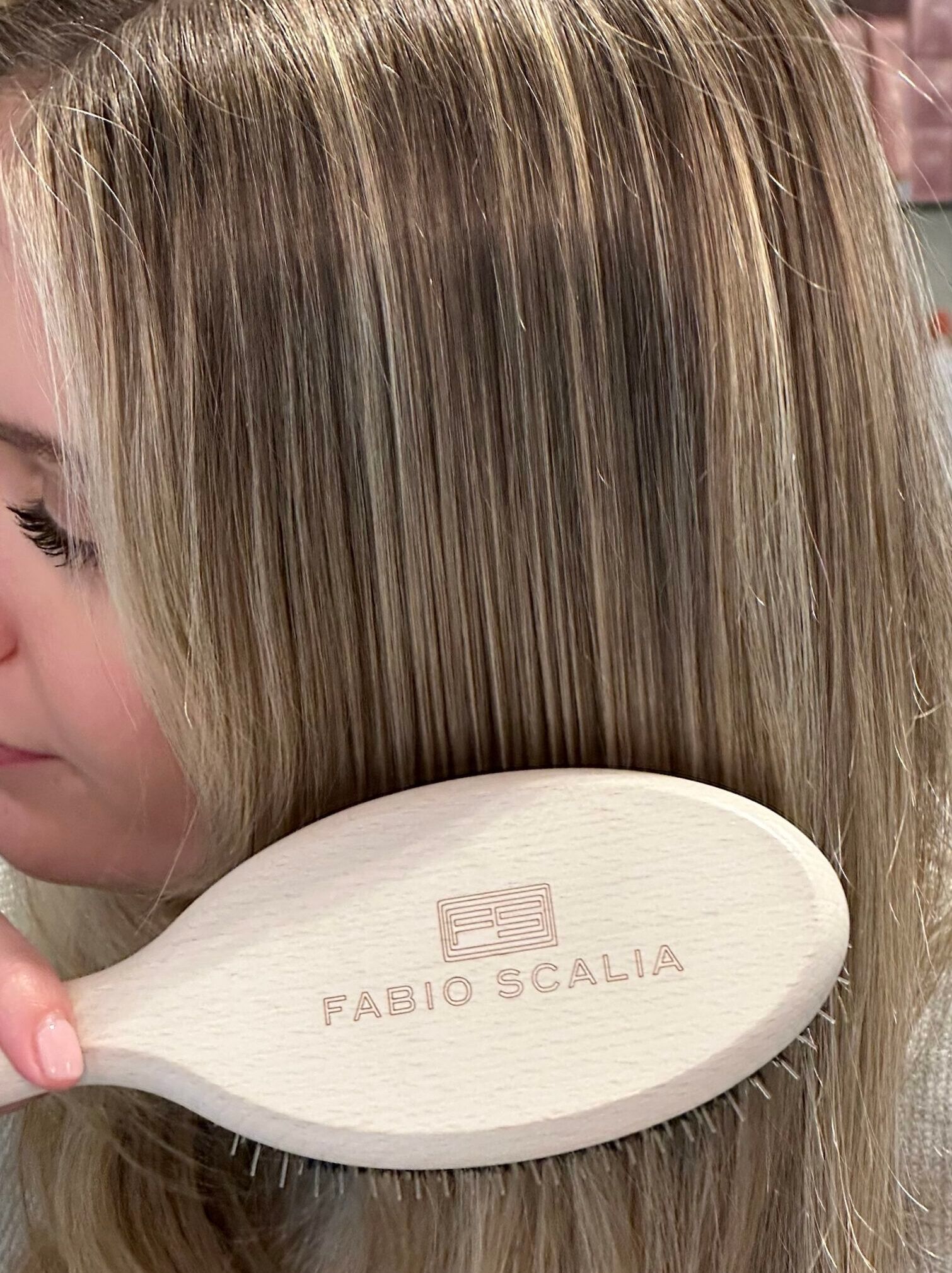 woman brushing her hair using boar bristle brush