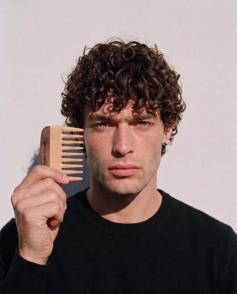 Male model holding wooden Fabio Scalia comb
