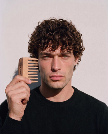 Male model holding wooden Fabio Scalia comb