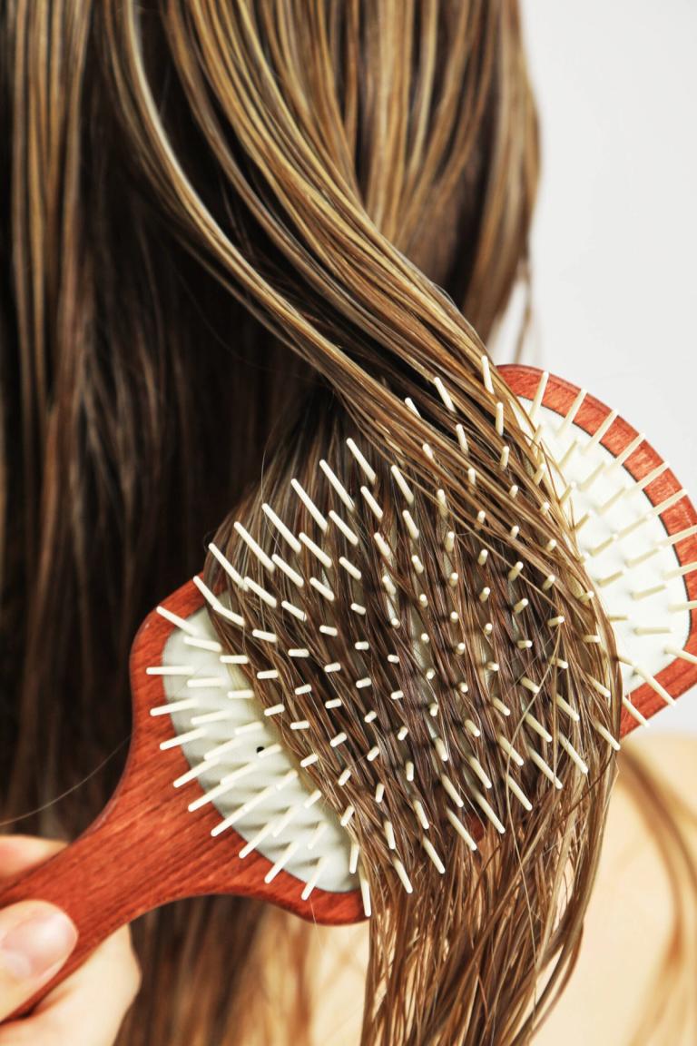 Claudia Paddle Brush gently detangling wet hair, distributing product evenly