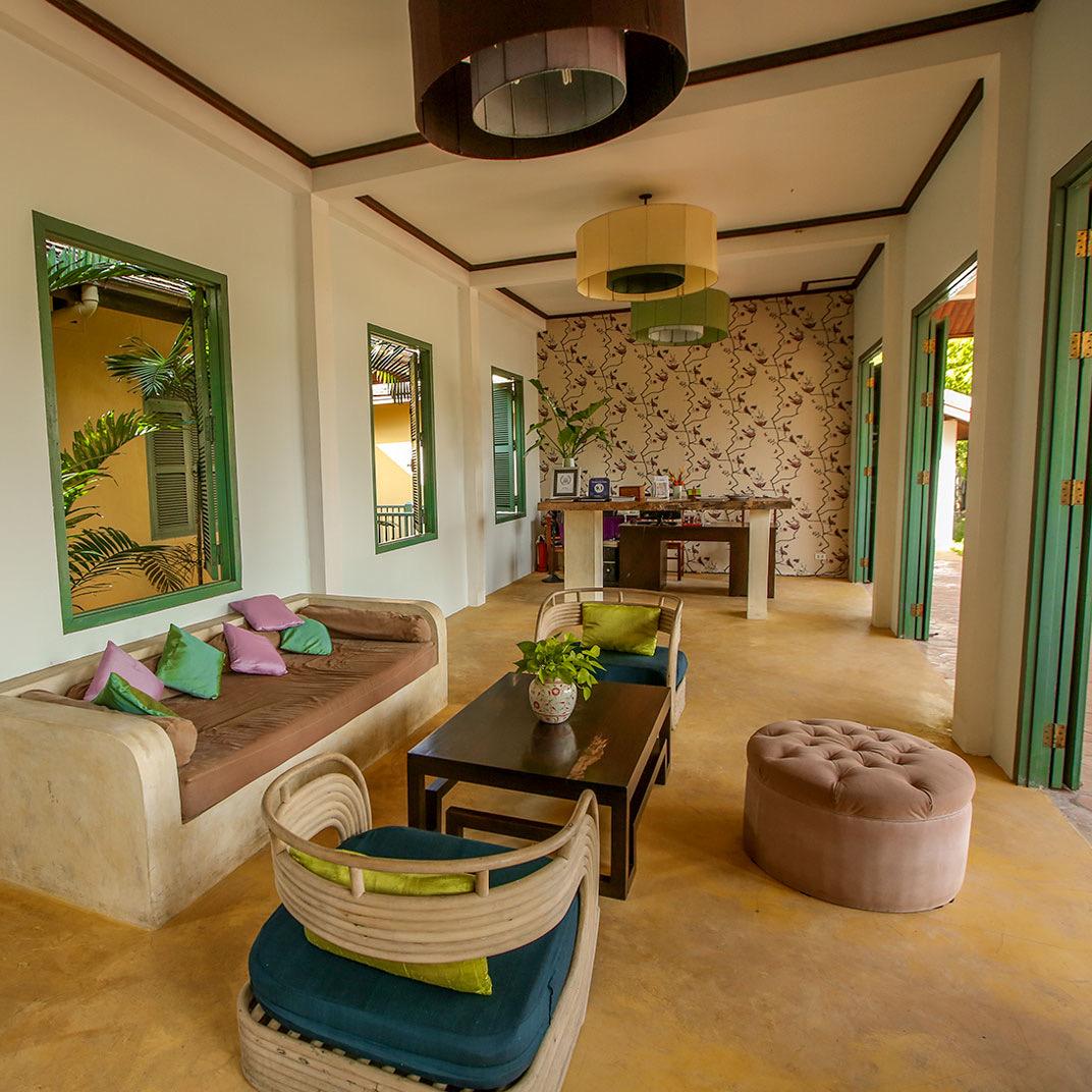 A sitting room with cushions under an arch
