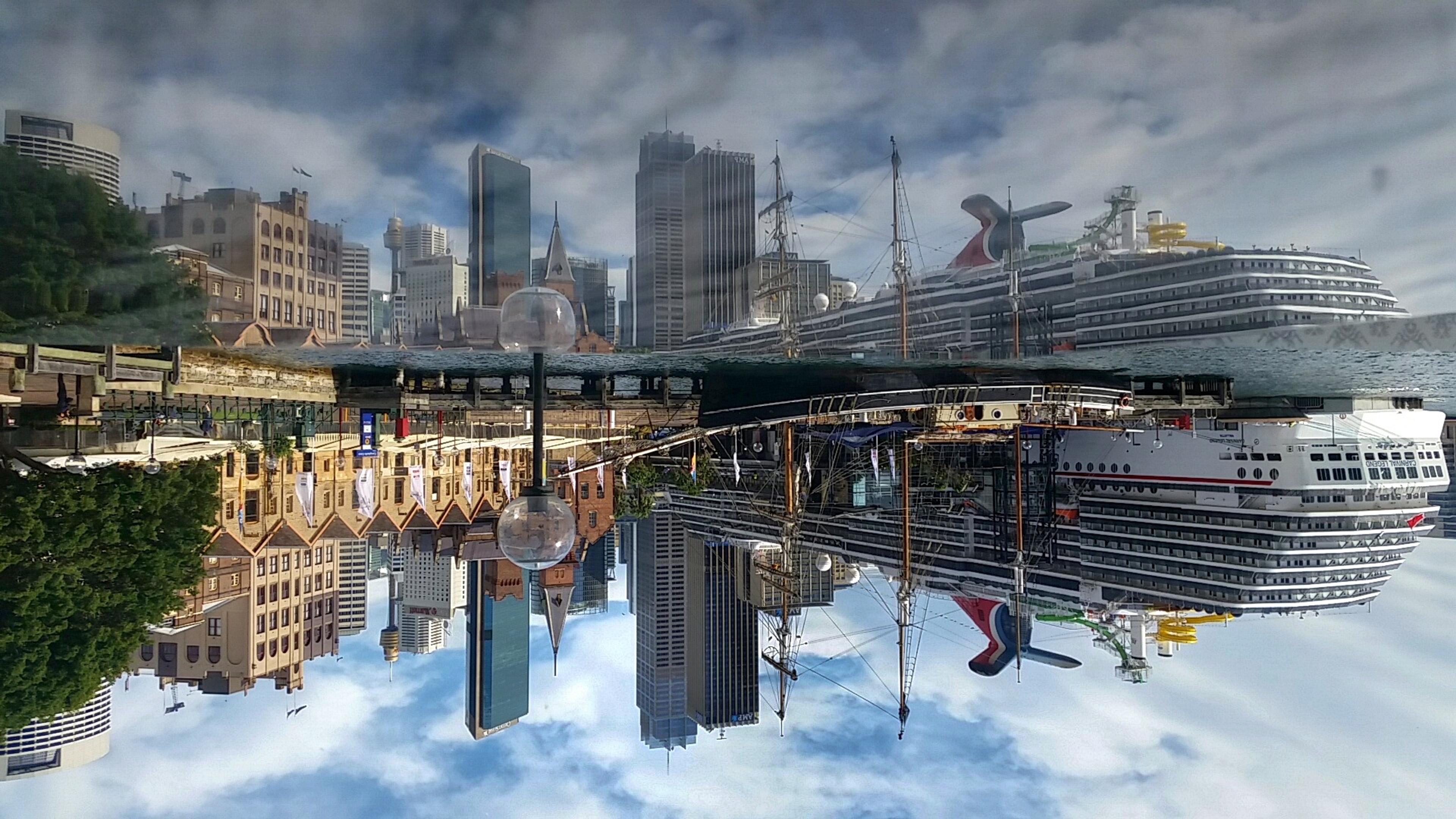 The Circular Quay skyline reflected in still water, seen from the hotel lobby