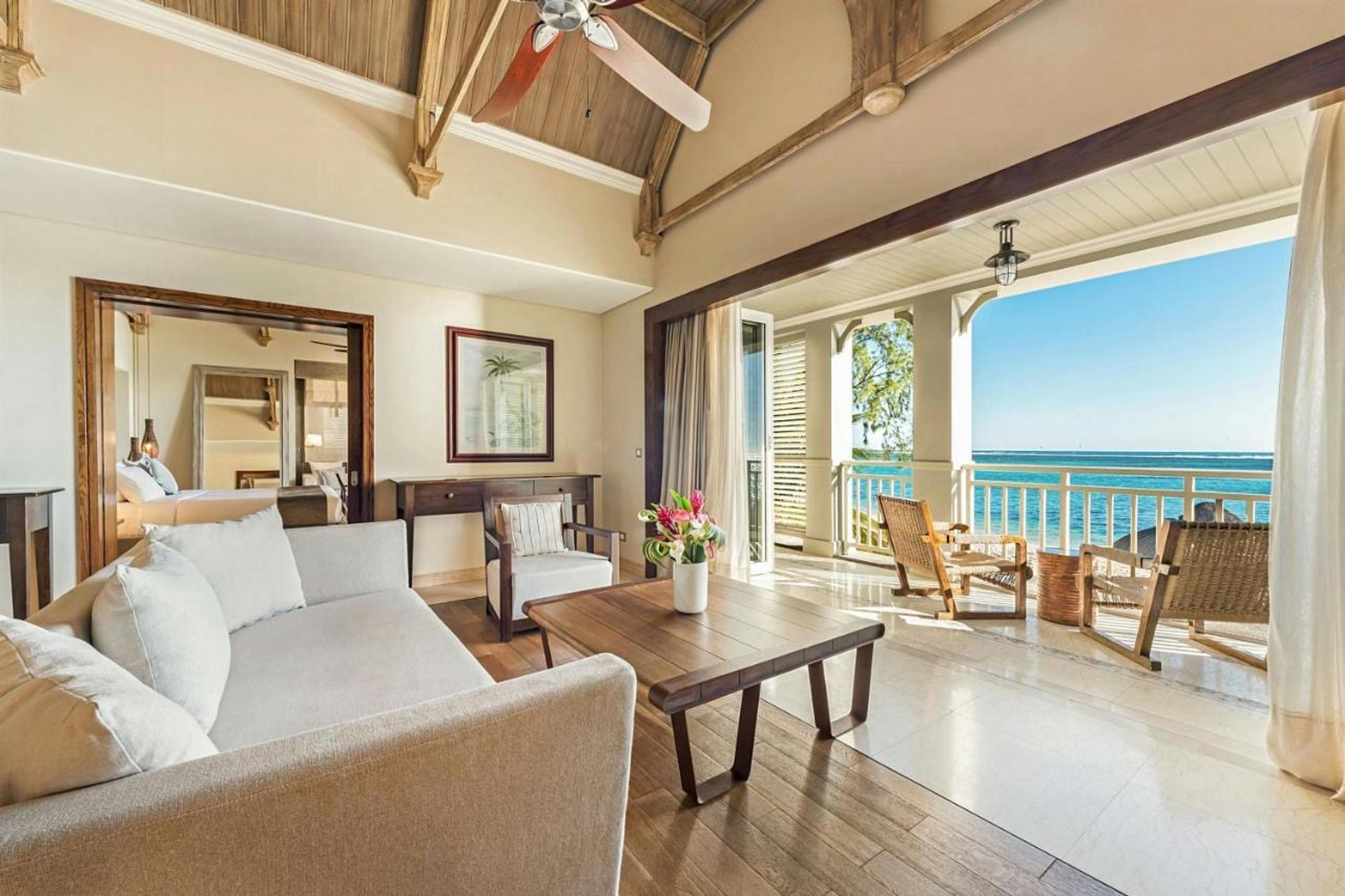 A bedroom with a sea view through open doors