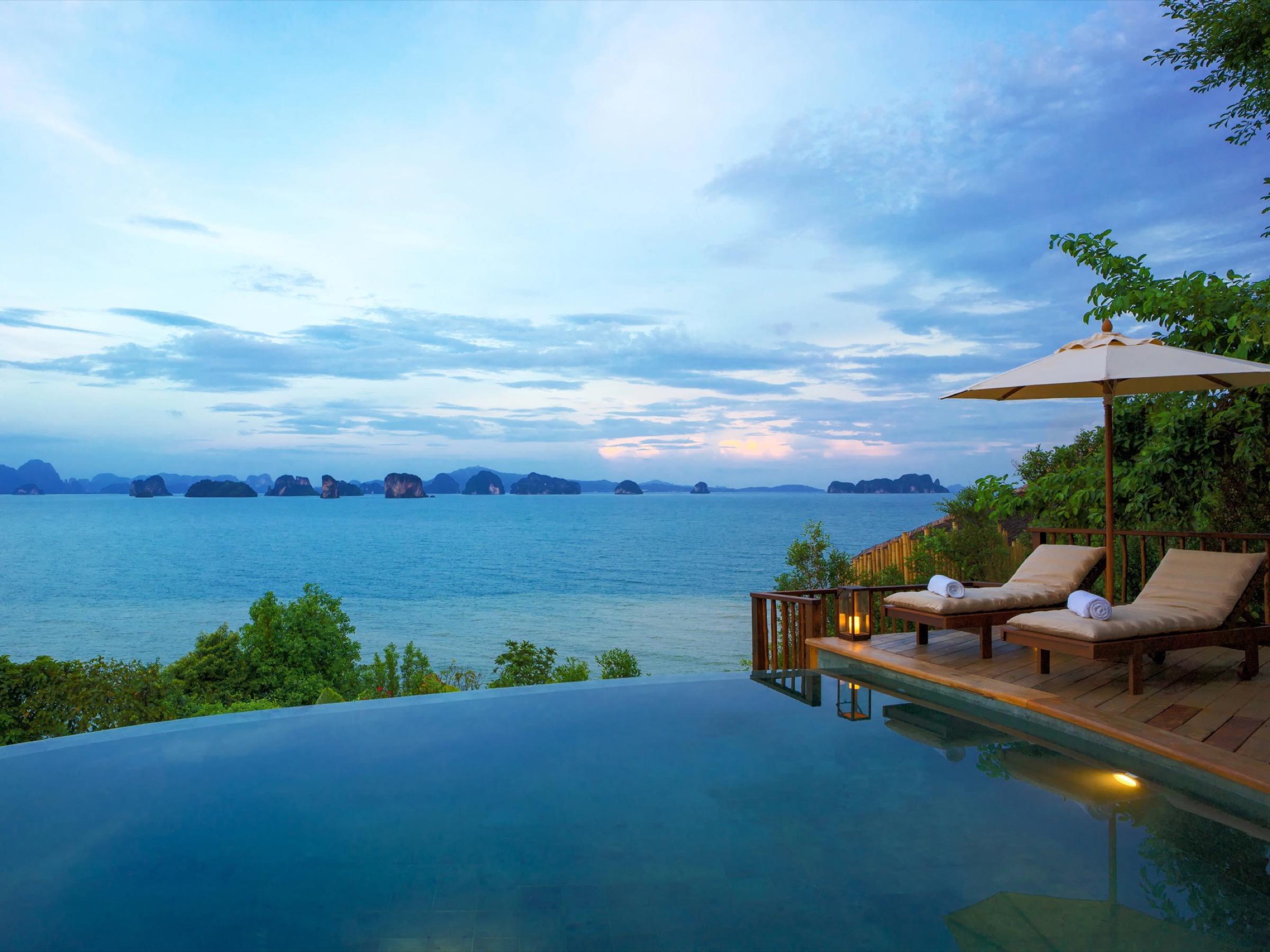 An infinity pool at Six Senses Yao Noi at dusk, looking over Phang Nga Bay to the limestone islands