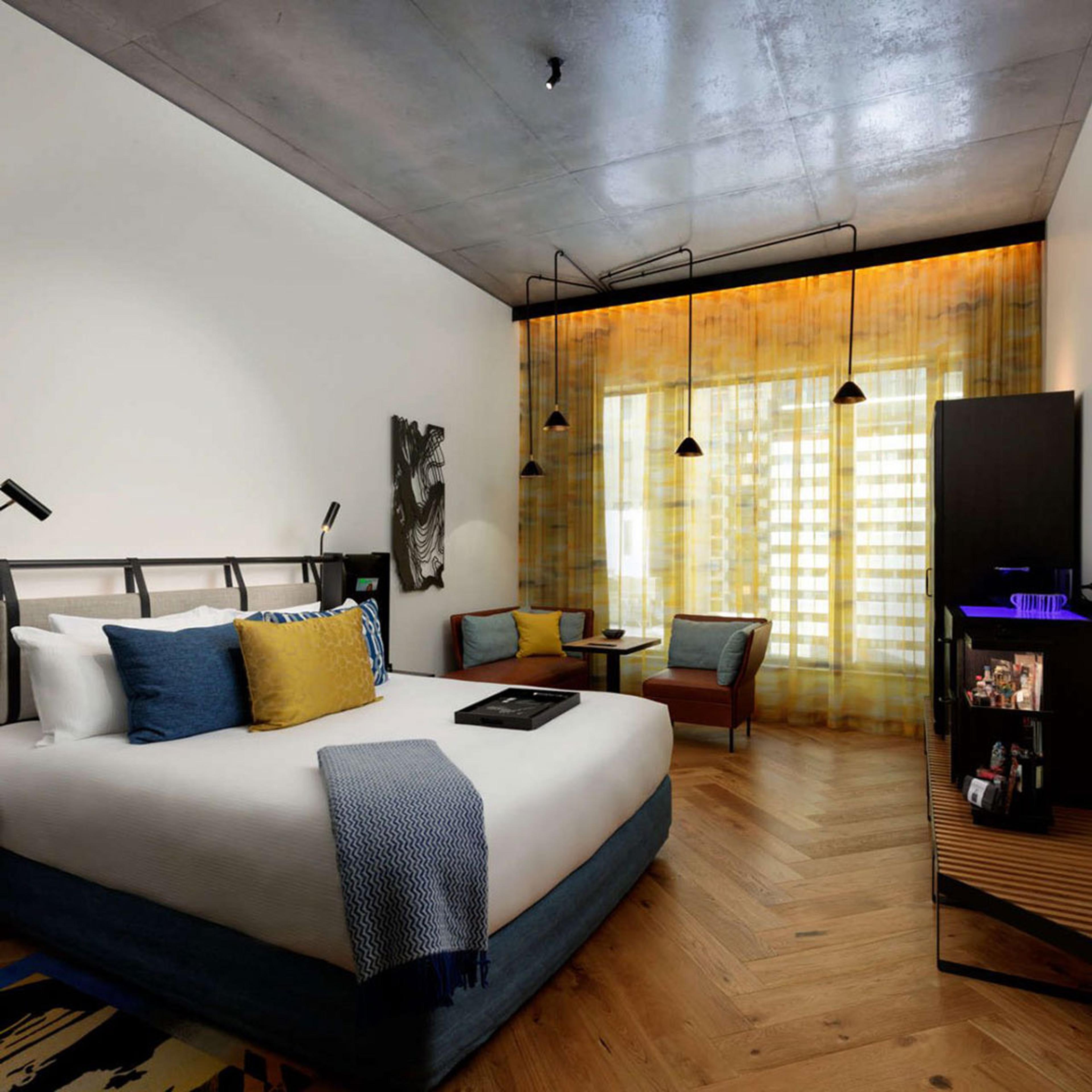 A bedroom lit warm through a yellow window screen
