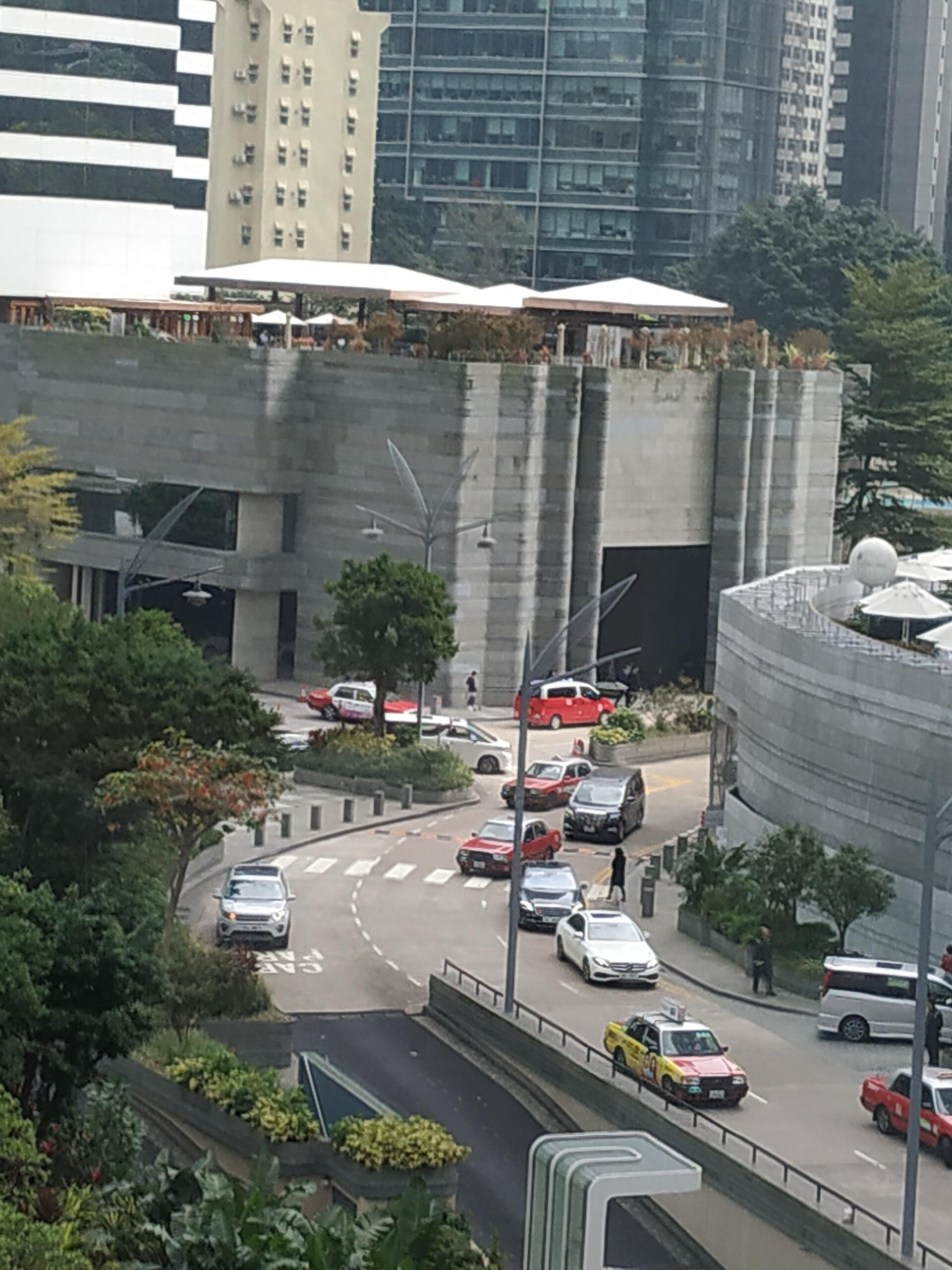 The hotel's tower above the trees and the road up from Pacific Place