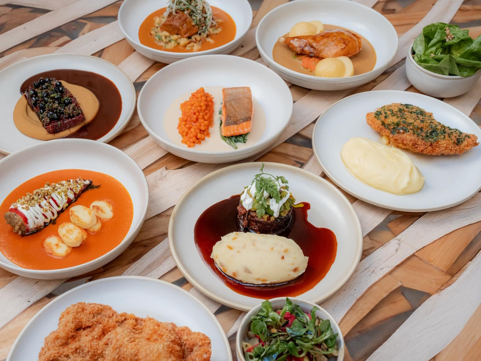 A spread of small plates on a marble table, seen from above