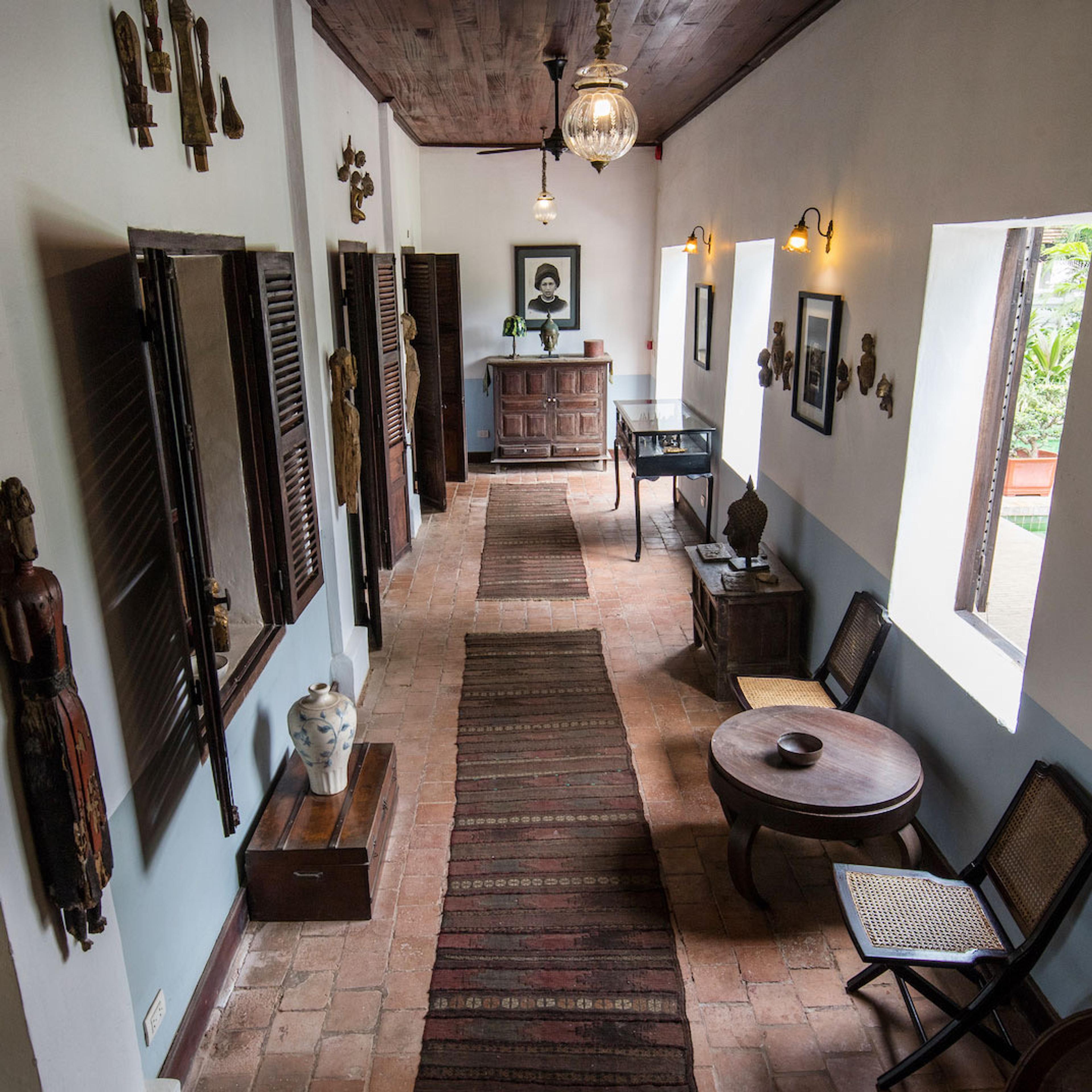 A long hallway furnished with dark wood